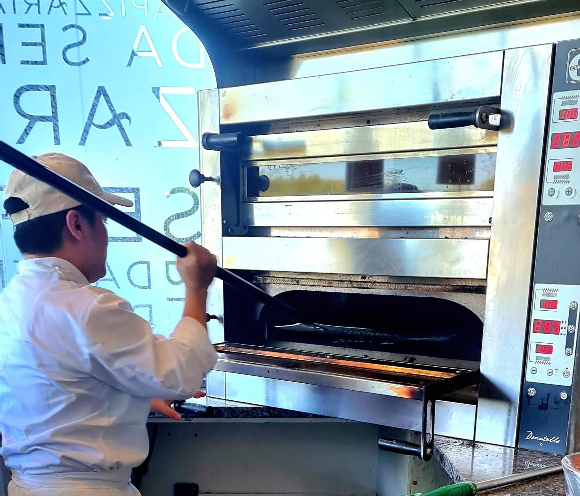 Monchique Resort & Spa Exterior photo A pizzaiolo baking a pizza in a wood-fired oven